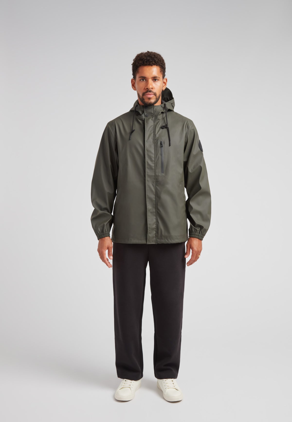 ELEMENTS Unisex Raincoat 2.0 Khaki worn by a model, showcasing lightweight weather protection in a stylish design.