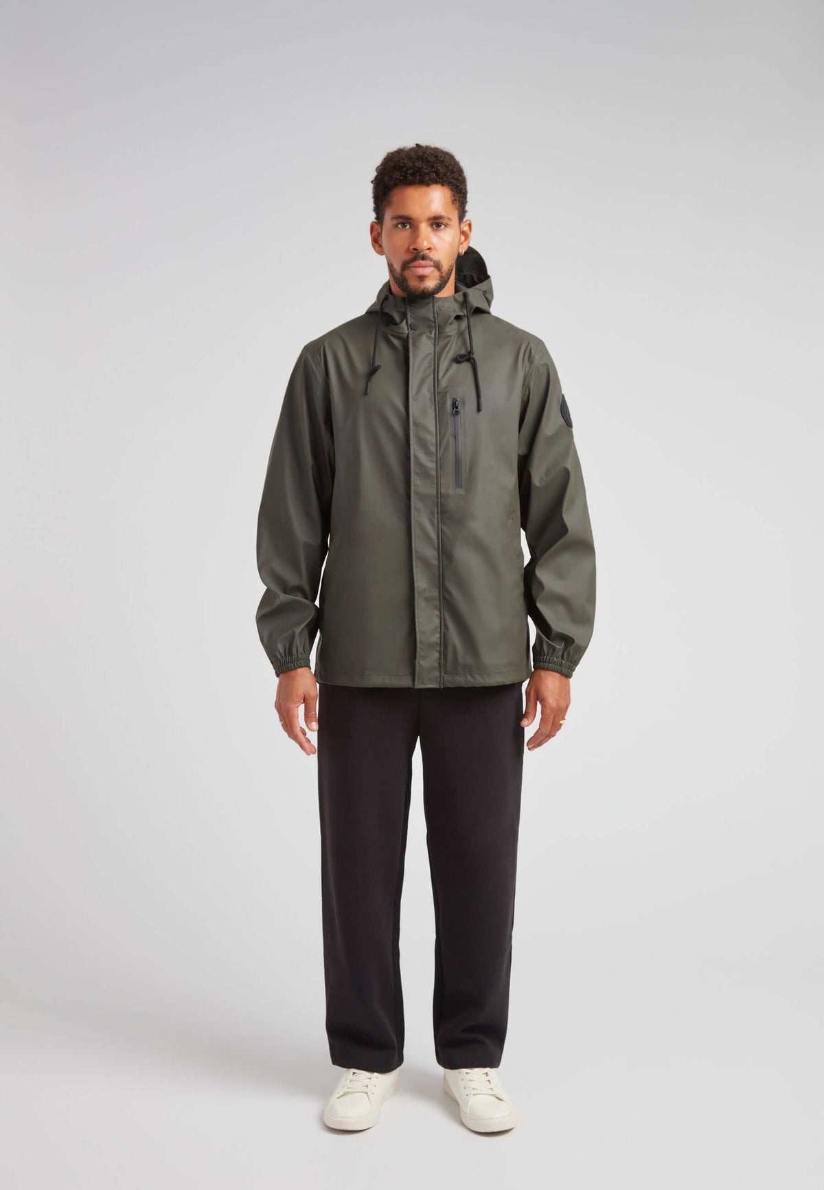 ELEMENTS Unisex Raincoat 2.0 Khaki worn by a model, showcasing lightweight weather protection in a stylish design.