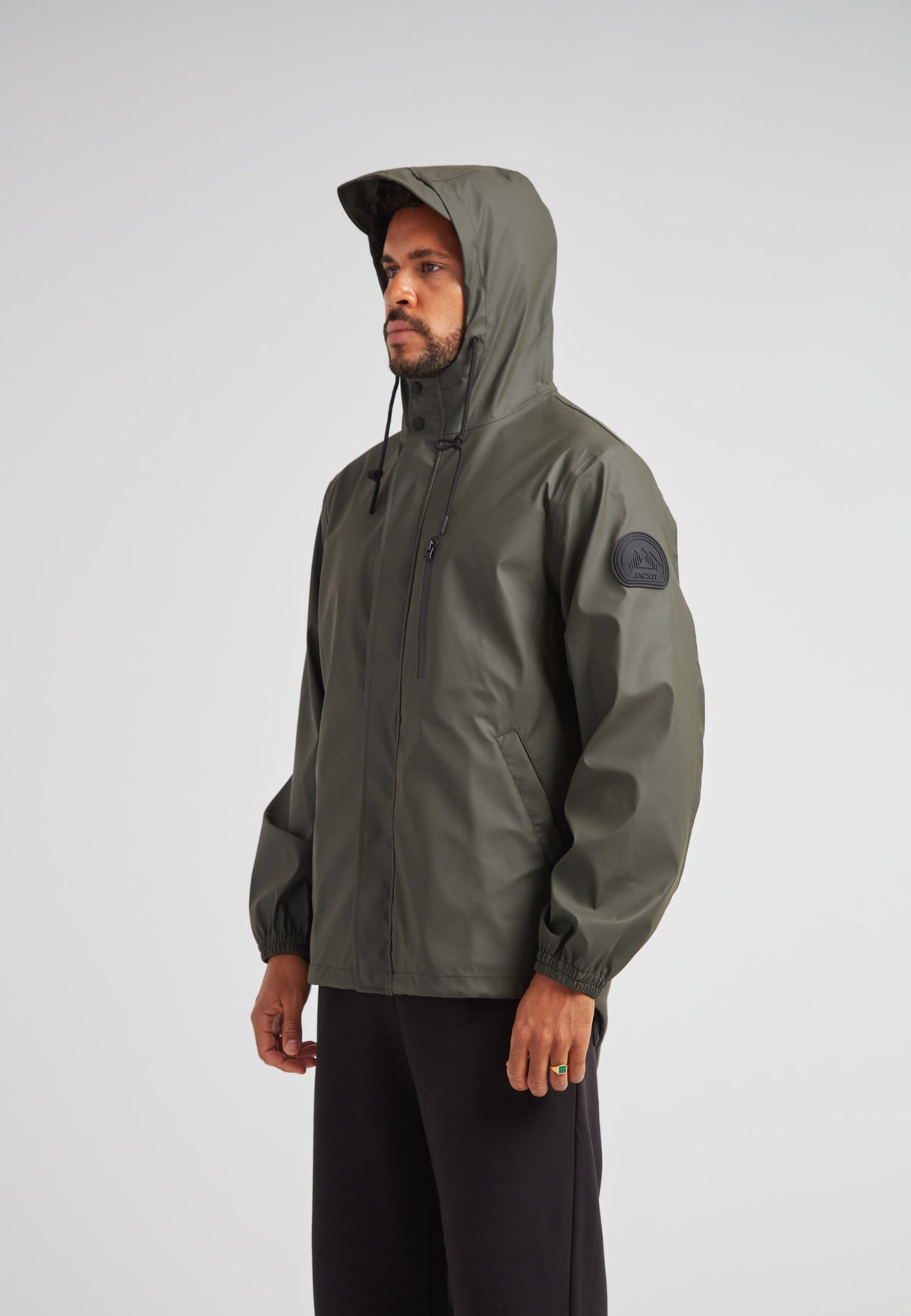 IMAGE of ELEMENTS Unisex Raincoat 2.0 Khaki worn by a model, showcasing lightweight weather protection features.