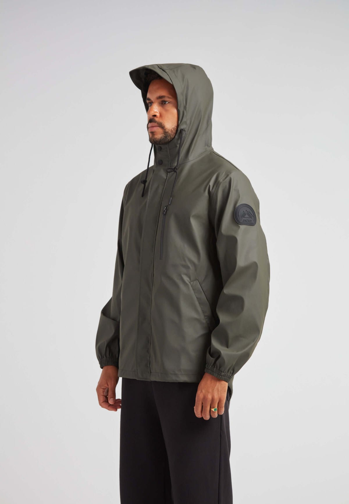 IMAGE of ELEMENTS Unisex Raincoat 2.0 Khaki worn by a model, showcasing lightweight weather protection features.