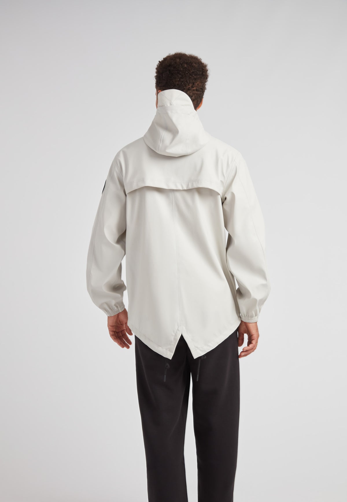 Back view of ELEMENTS Unisex Raincoat 2.0 Stone, showcasing its stylish design and practical features.