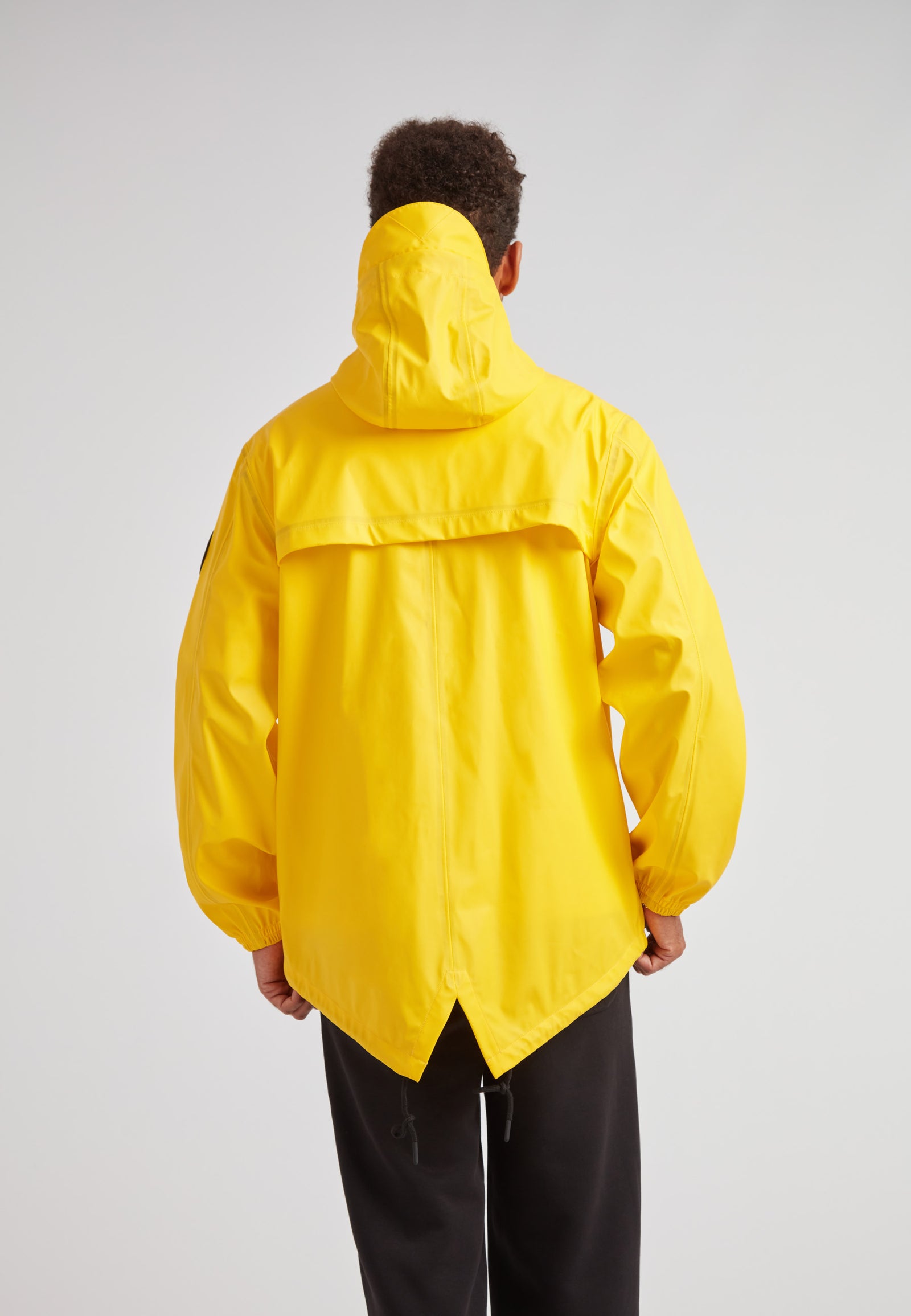 Back view of ELEMENTS Unisex Raincoat 2.0 Yellow, showcasing its stylish design and vibrant color.
