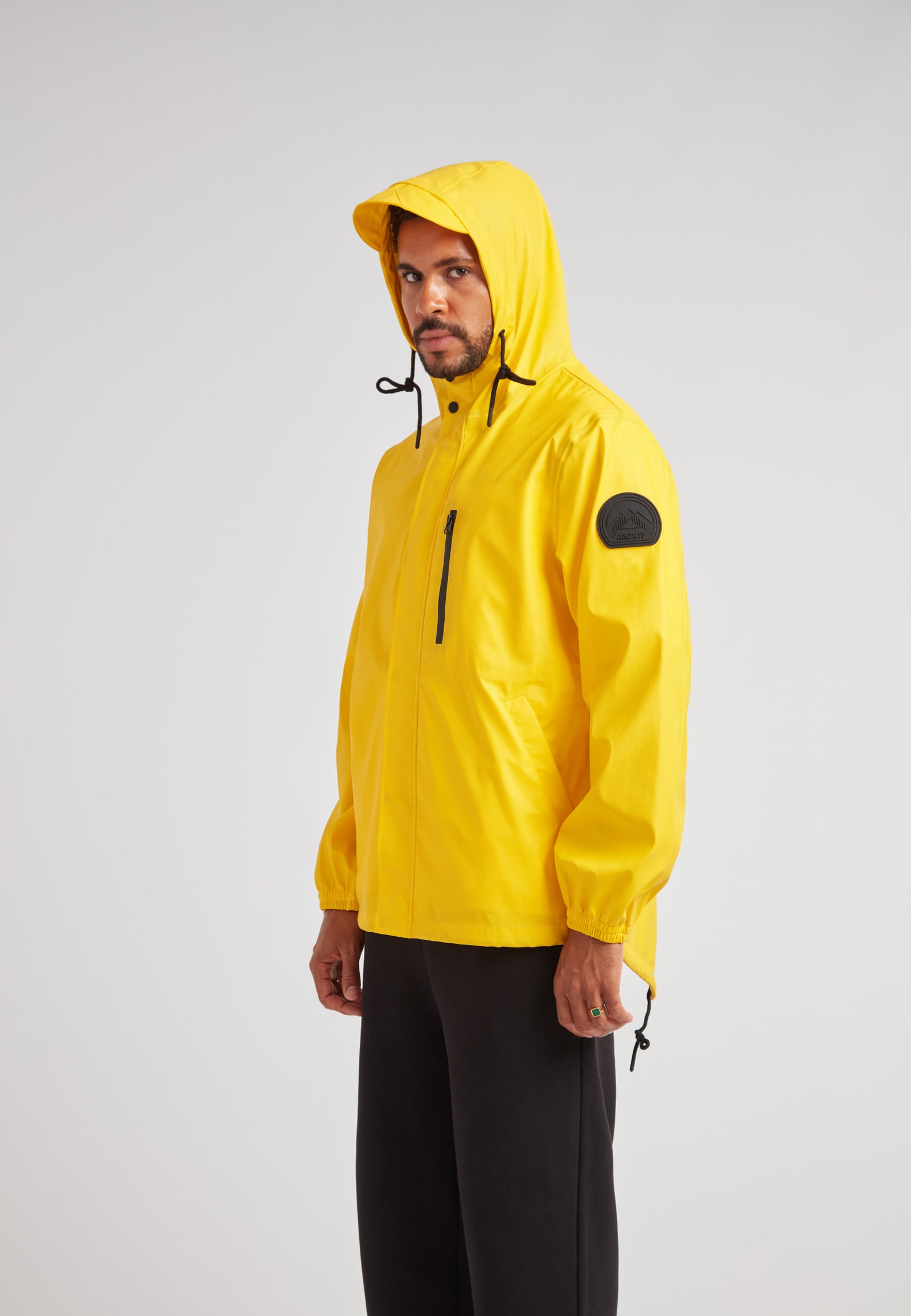 ELEMENTS Unisex Raincoat 2.0 Yellow displayed on a model, featuring a hood and black accents.