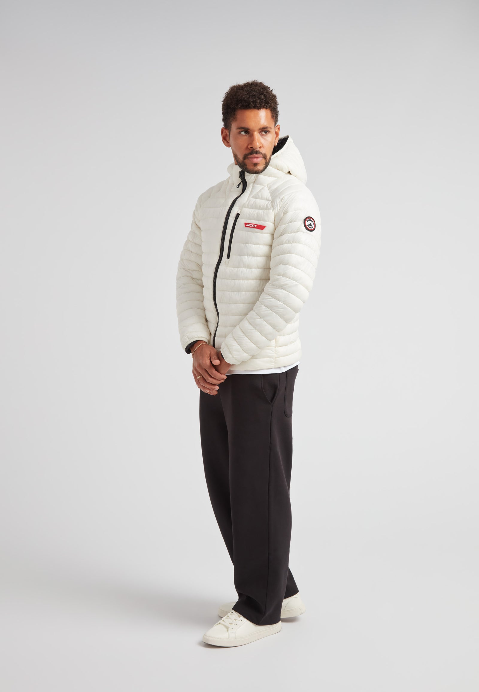 Man wearing SATEL1TE Hooded Jacket 2.0 Vintage White, showcasing its stylish design and lightweight comfort.