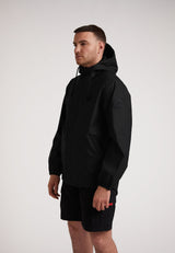 Man wearing ELEMENTS Unisex Raincoat 2.0 Black, showcasing lightweight weather protection and style.