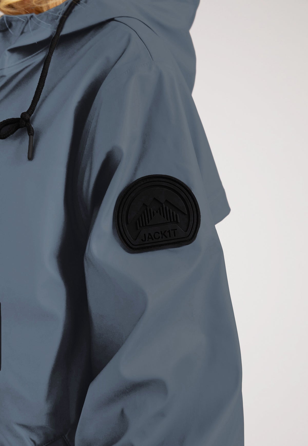 Close-up of the ELEMENTS Raincoat 2.0 Grey showcasing the logo and patch detail on the sleeve.