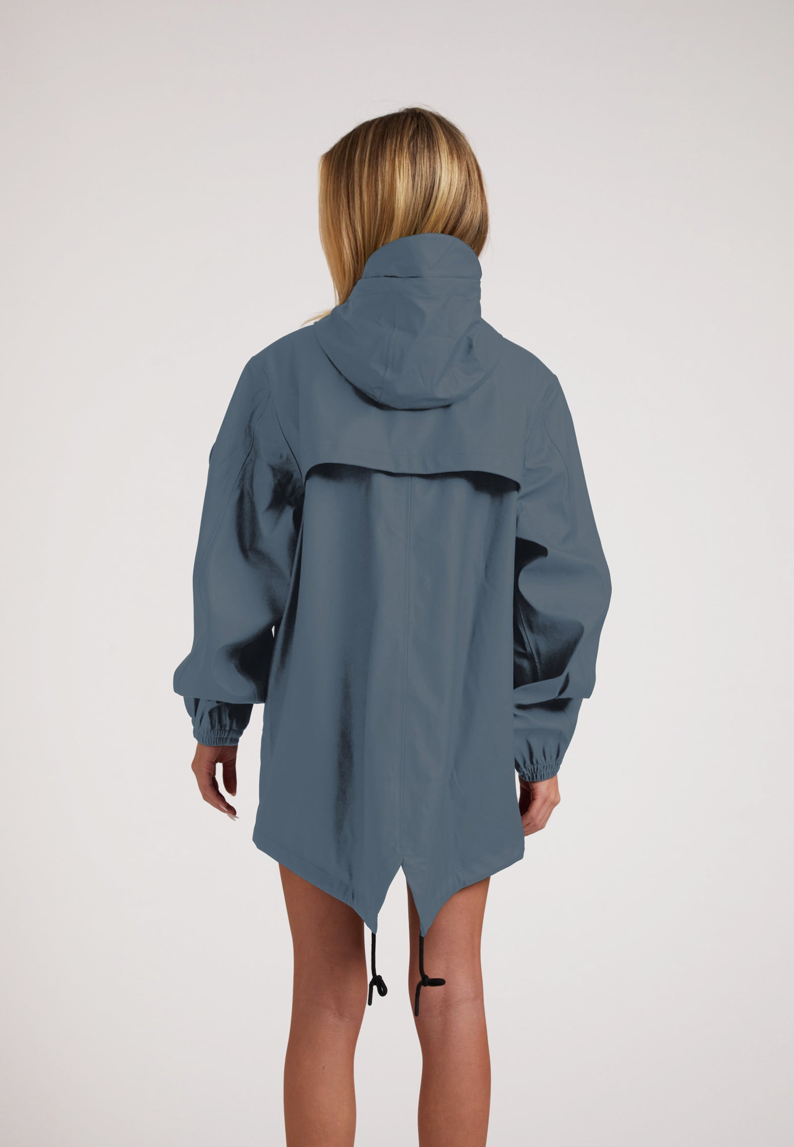 Woman wearing ELEMENTS Raincoat 2.0 Grey from the back, showcasing its lightweight design and comfortable fit.