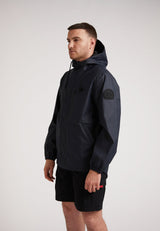 Man modeling ELEMENTS Unisex Raincoat 2.0 Navy, showcasing its lightweight design and weather protection features.
