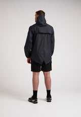 Man wearing ELEMENTS Unisex Raincoat 2.0 Navy seen from the back, showcasing its lightweight and stylish design.