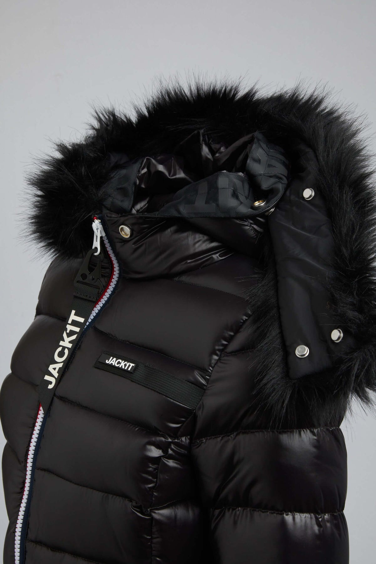 Black puffer jacket with fur hood showcasing stylish design and high-quality materials.
