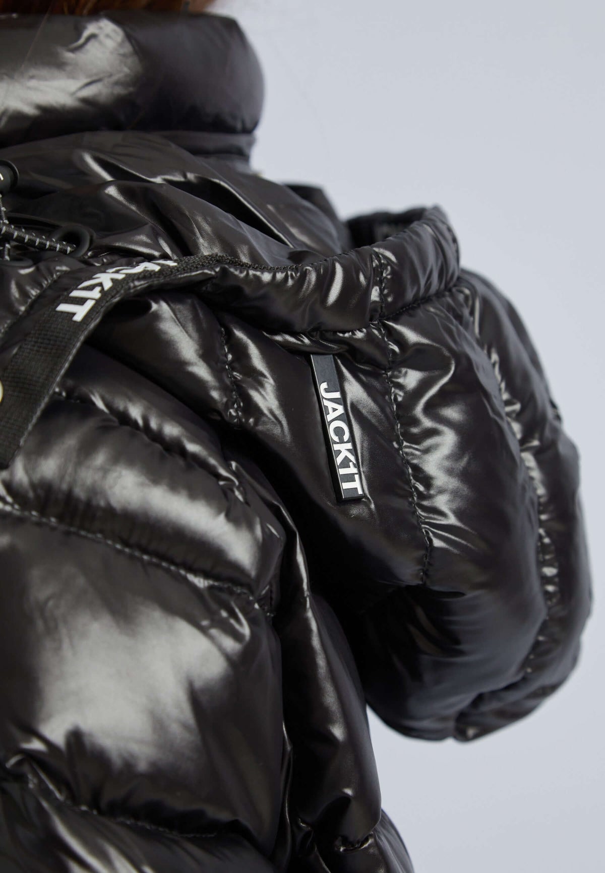 Close-up of the Squadra Slick Racer Jacket in black, showcasing its sleek design and shiny finish, perfect black puffer jacket womens.