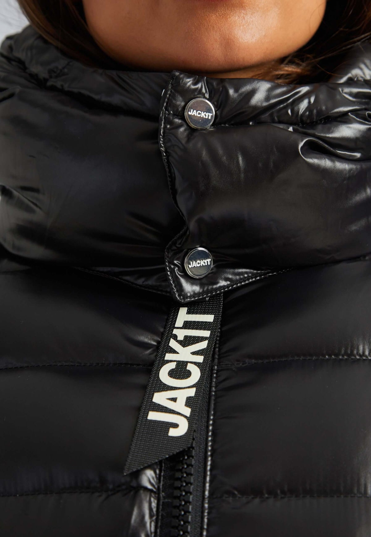 Close-up of the Squadra Slick Racer Jacket black puffer jacket womens with glossy finish and stylish zipper.