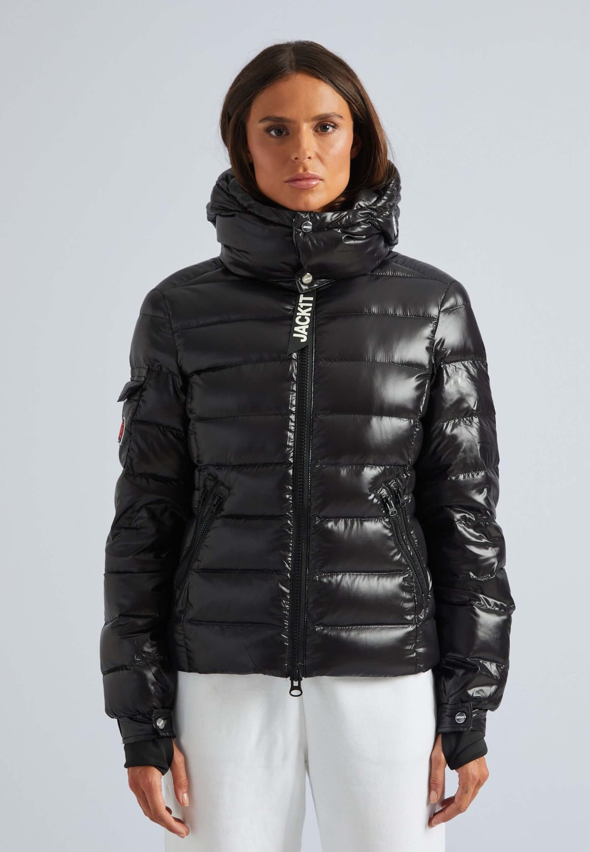 Model wearing a black puffer jacket womens with a detachable hood and a sleek finish.
