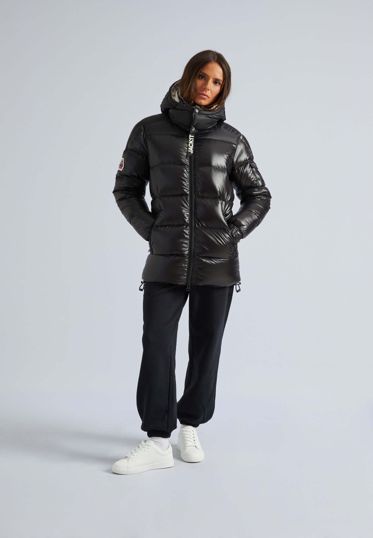 Model wearing women's black puffer with removable hood, showcasing a stylish and warm design.