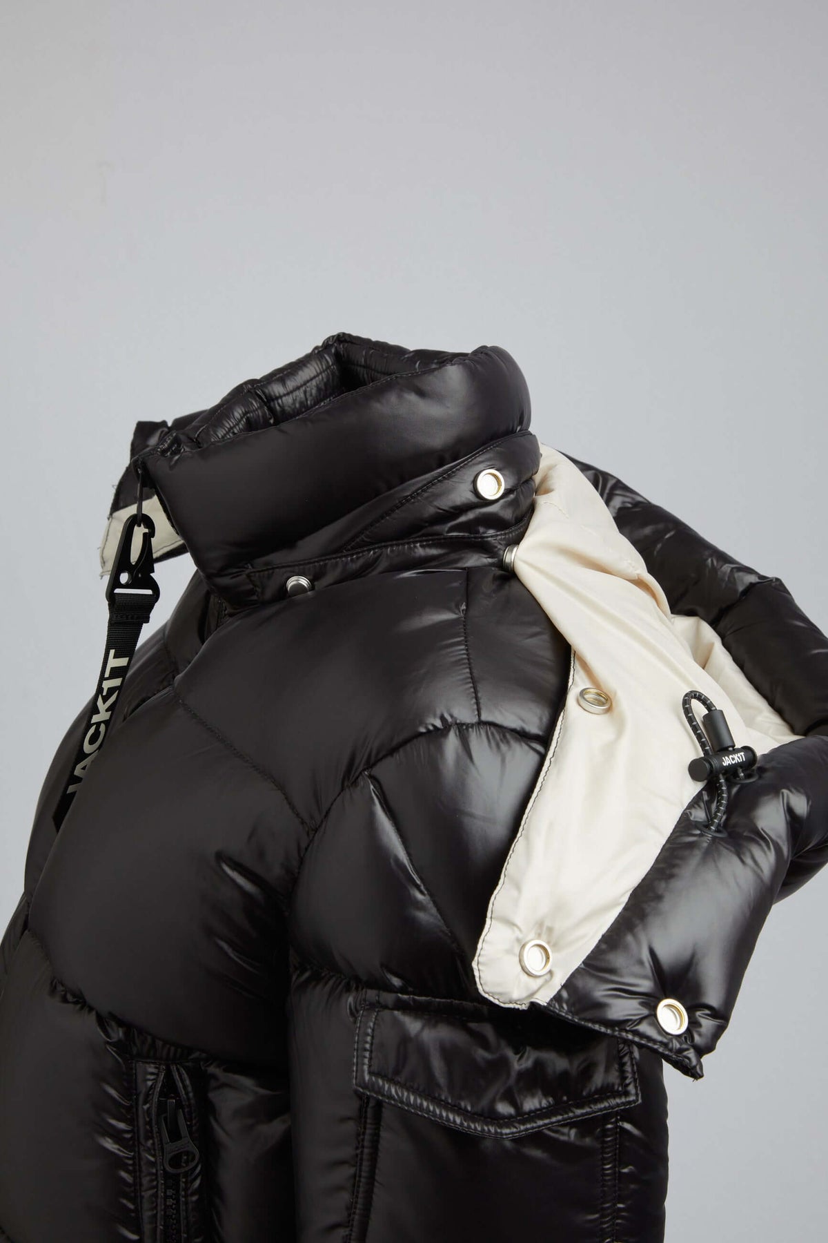 women's black puffer with removable hood showcased in a stylish design, featuring a 2-in-1 funnel collar.