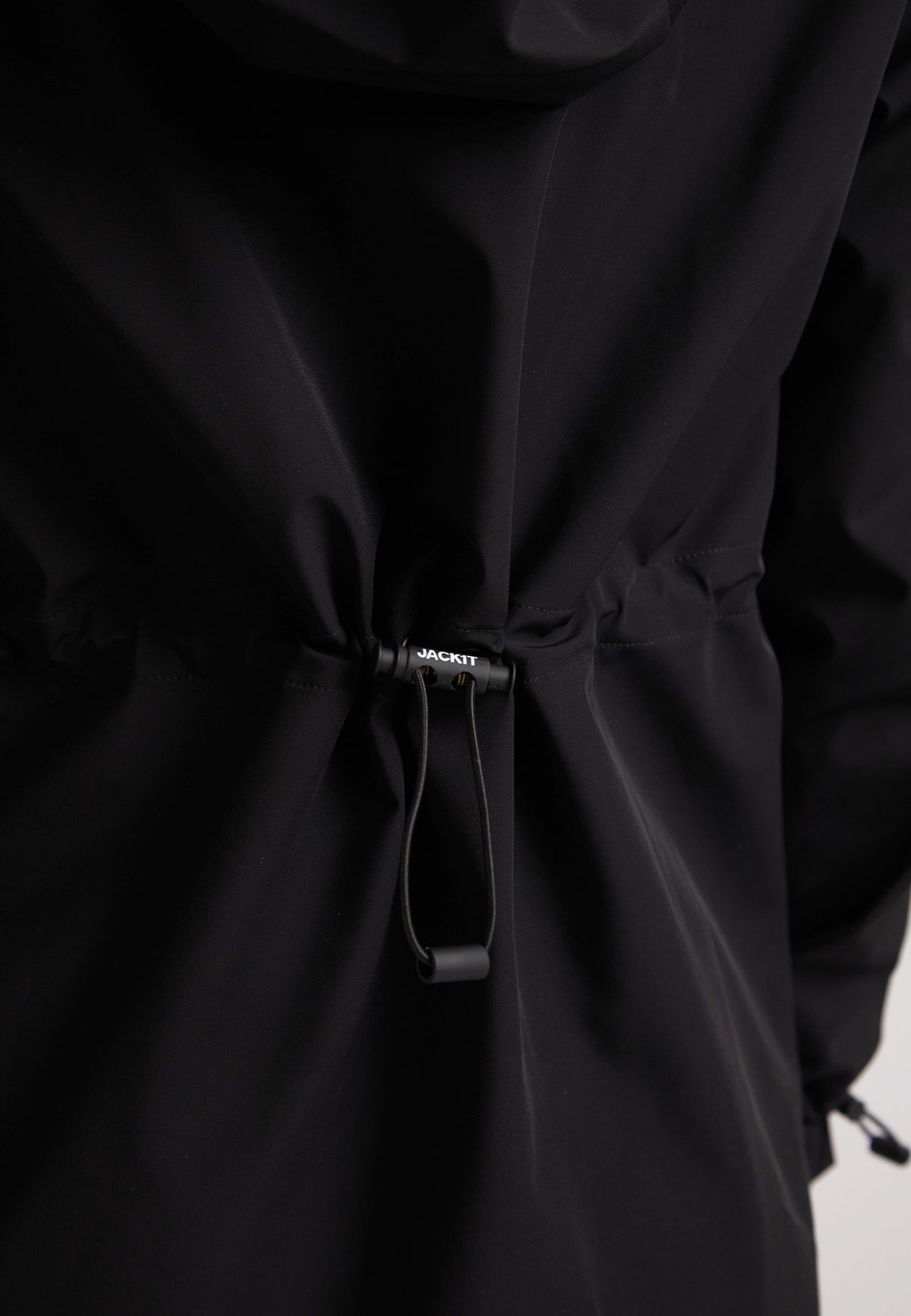 Back view of the HELIO Mid Windbreaker Black showcasing adjustable waist features.