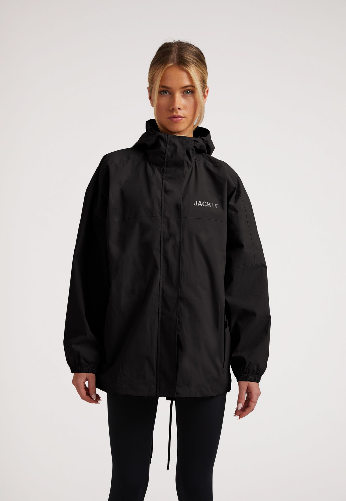 Model wearing ISOTOPE Ladies lightweight black windbreaker, showcasing its stylish and functional design.