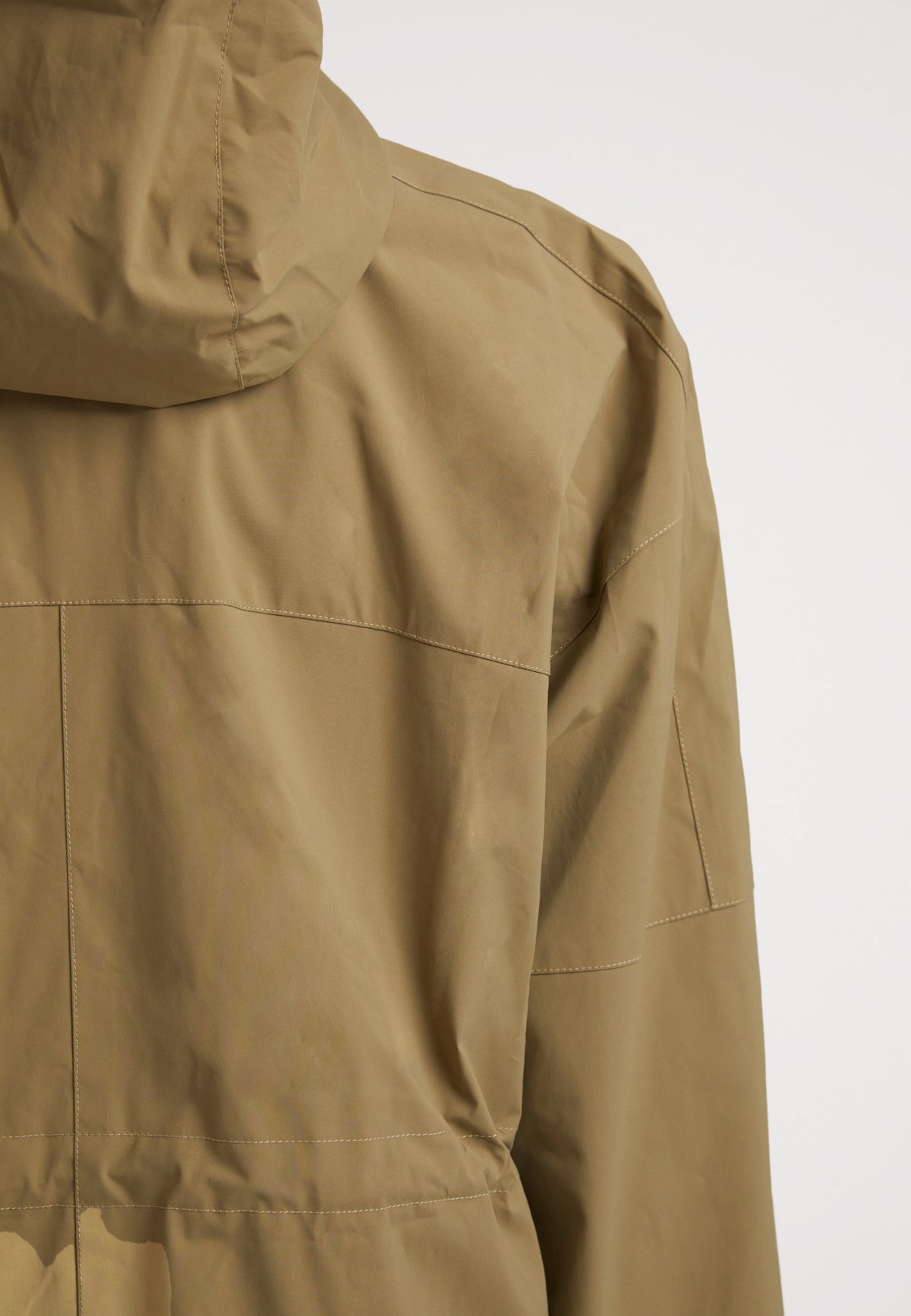 Back view of the ISOTOPE Ladies lightweight olive windbreaker featuring a hood and durable fabric.