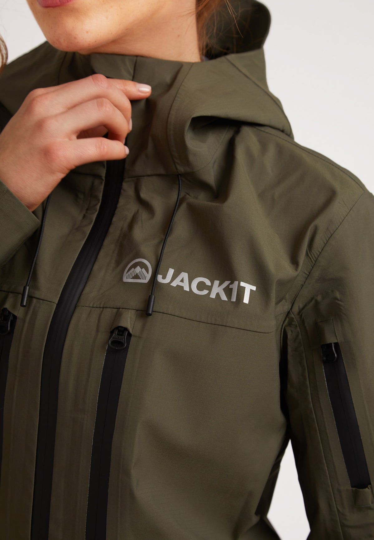 Waterproof ladies jacket in olive showing the design and logo, perfect for outdoor activities.