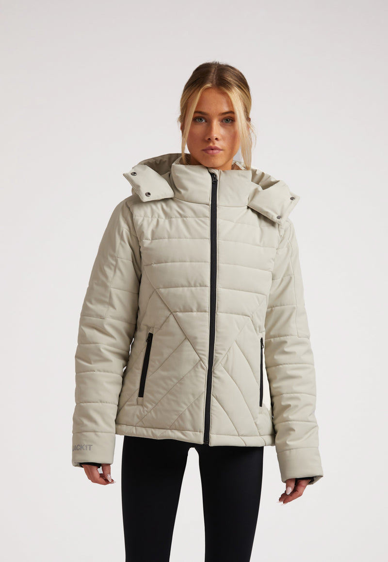 Model wearing ISOTOPE padded jacket, a ladies padded lightweight stone jacket with adjustable hood and stylish design.