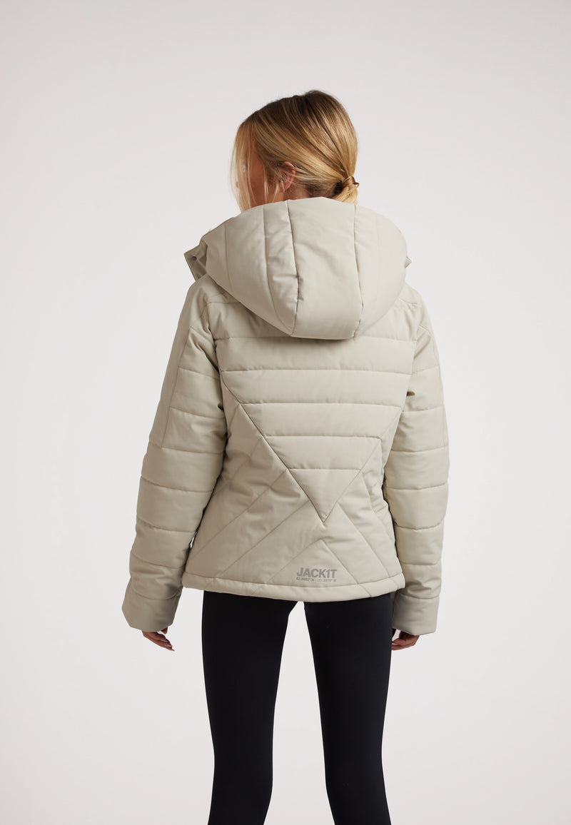 Back view of a model wearing an ISOTOPE Ladies padded lightweight stone jacket with hood.