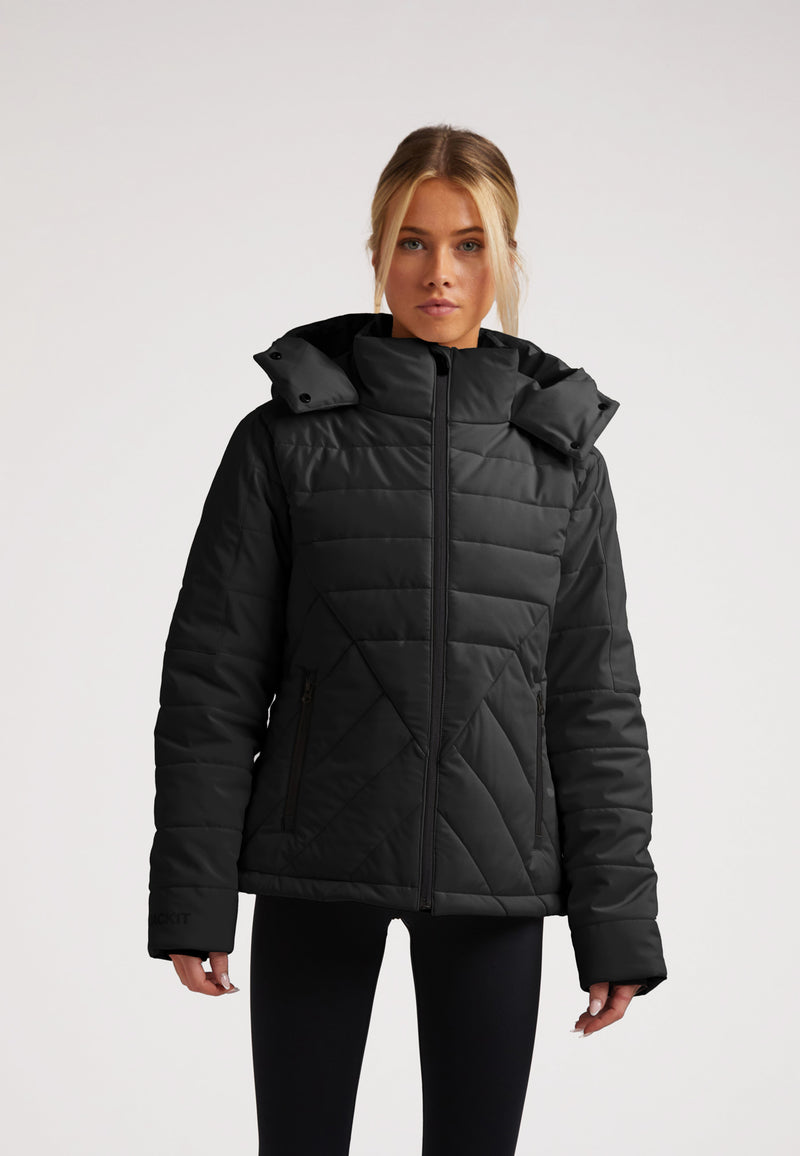 ISOTOPE Padded Jacket Black worn by a model, showcasing its windproof design and adjustable hood.