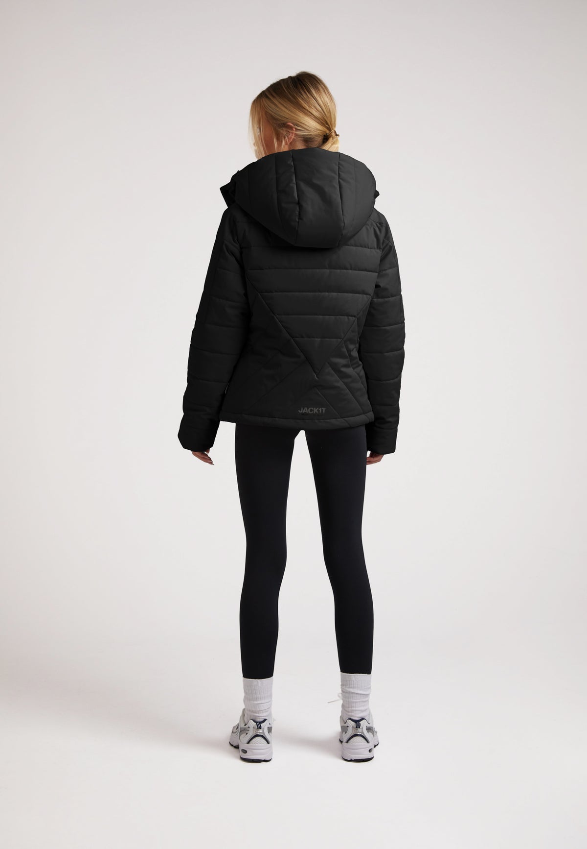 ISOTOPE Padded Jacket Black displayed on a model from the back, featuring a hood and padded design for warmth.