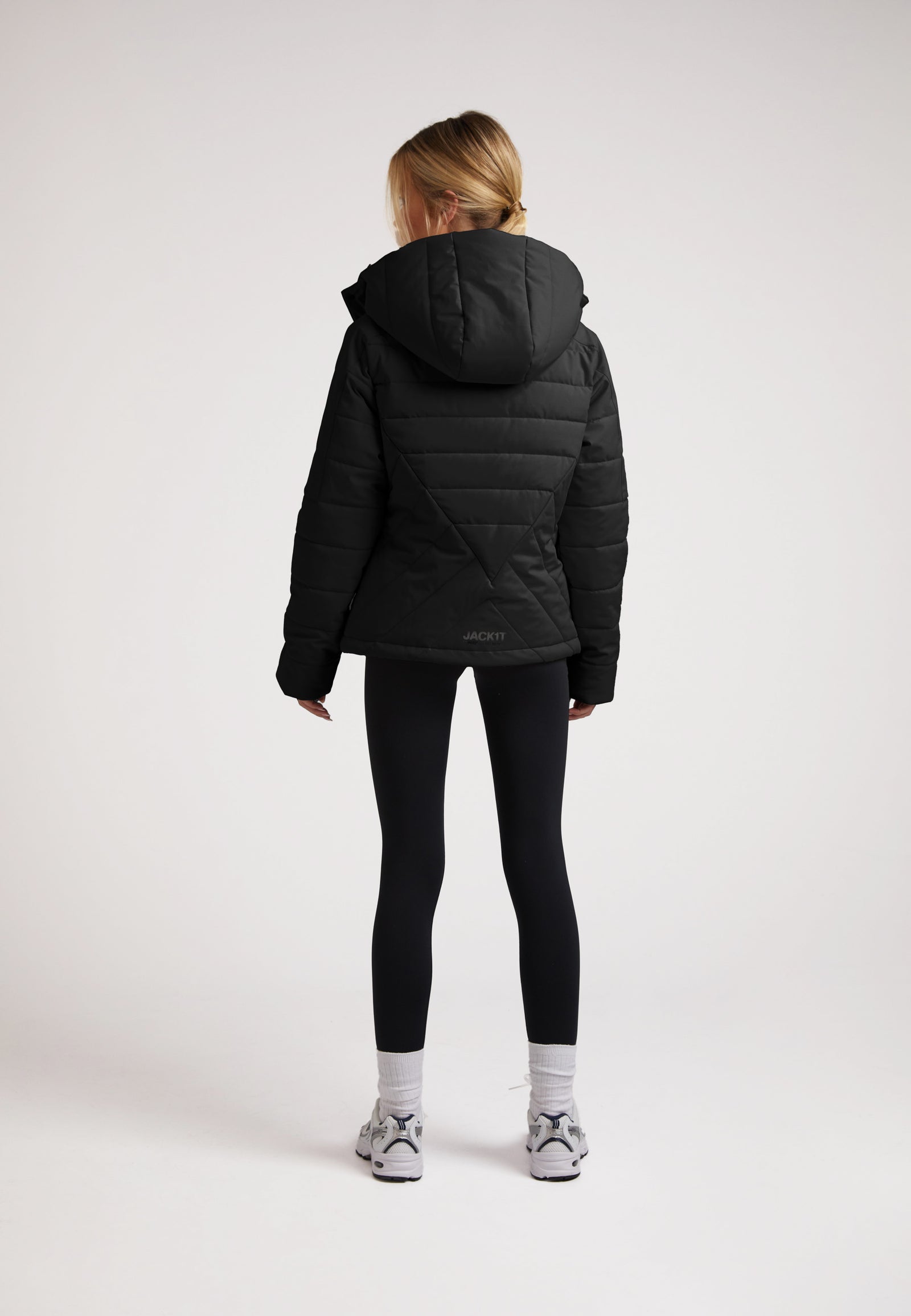 ISOTOPE Padded Jacket Black displayed on a model from the back, featuring a hood and padded design for warmth.