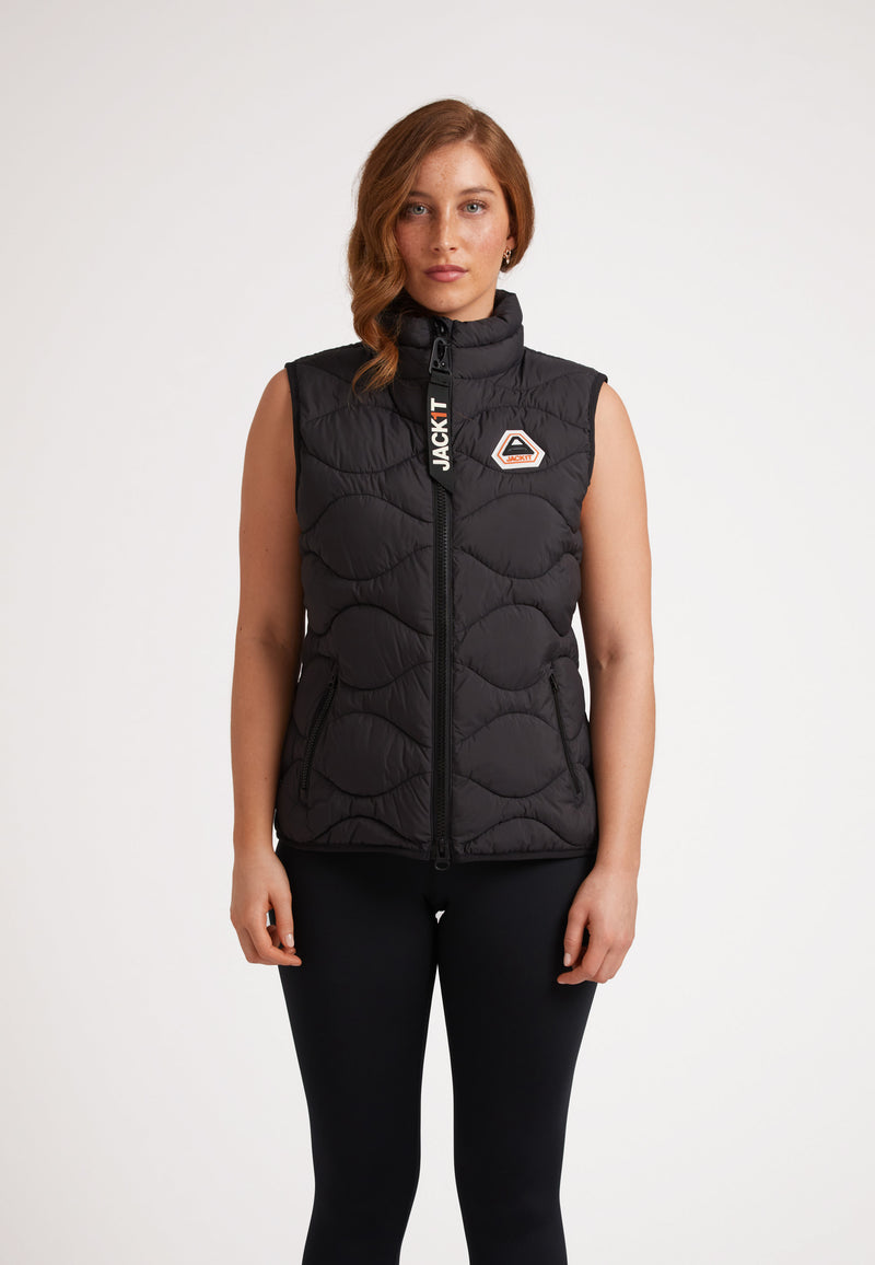 Woman wearing ORB1T Quilted Gilet Black, showcasing its stylish design and onion baffle insulation.