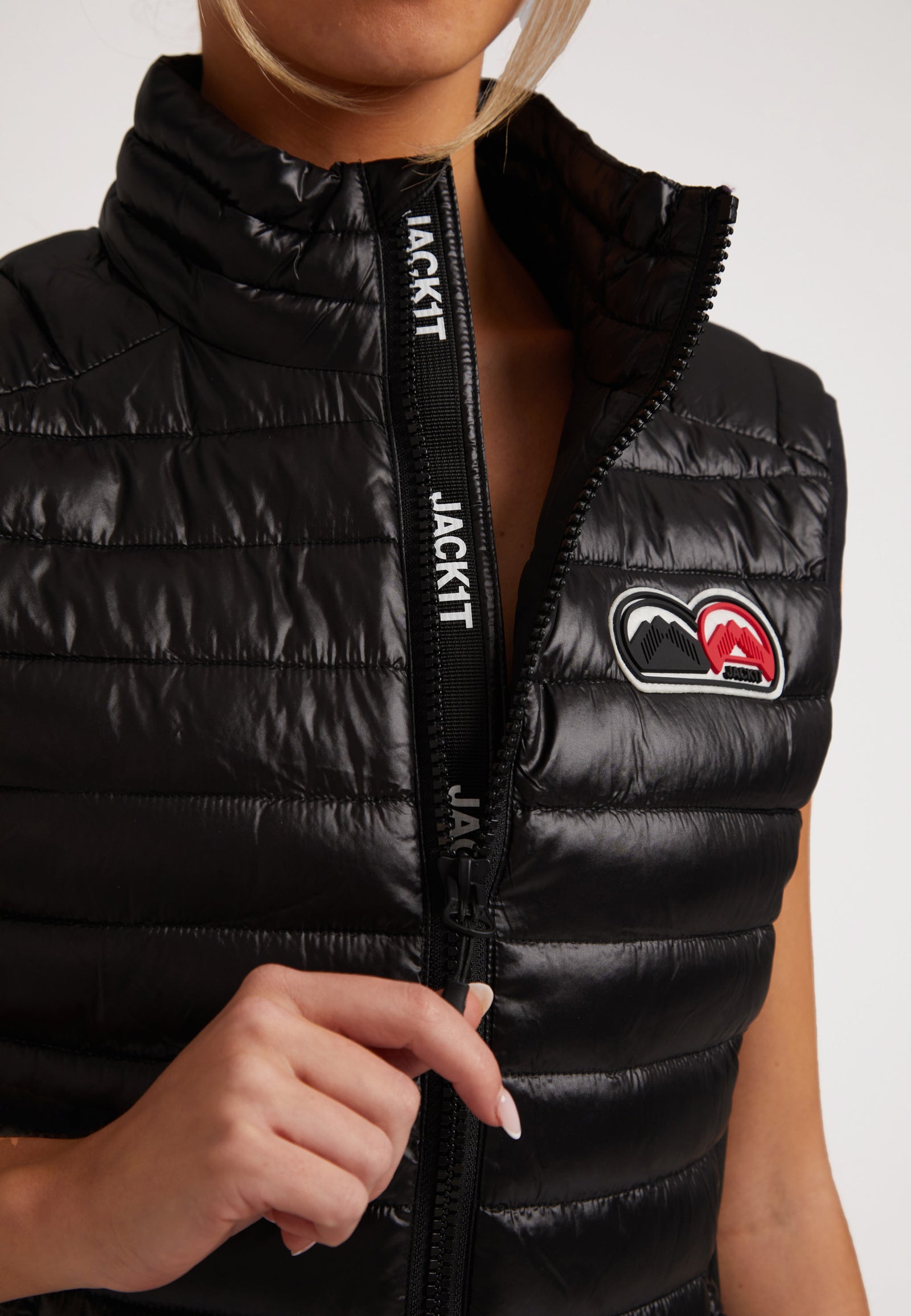 SPORTL1TE Funnel Lightweight Gilet 2.0 Lux Black showcasing its stylish zip and logo.