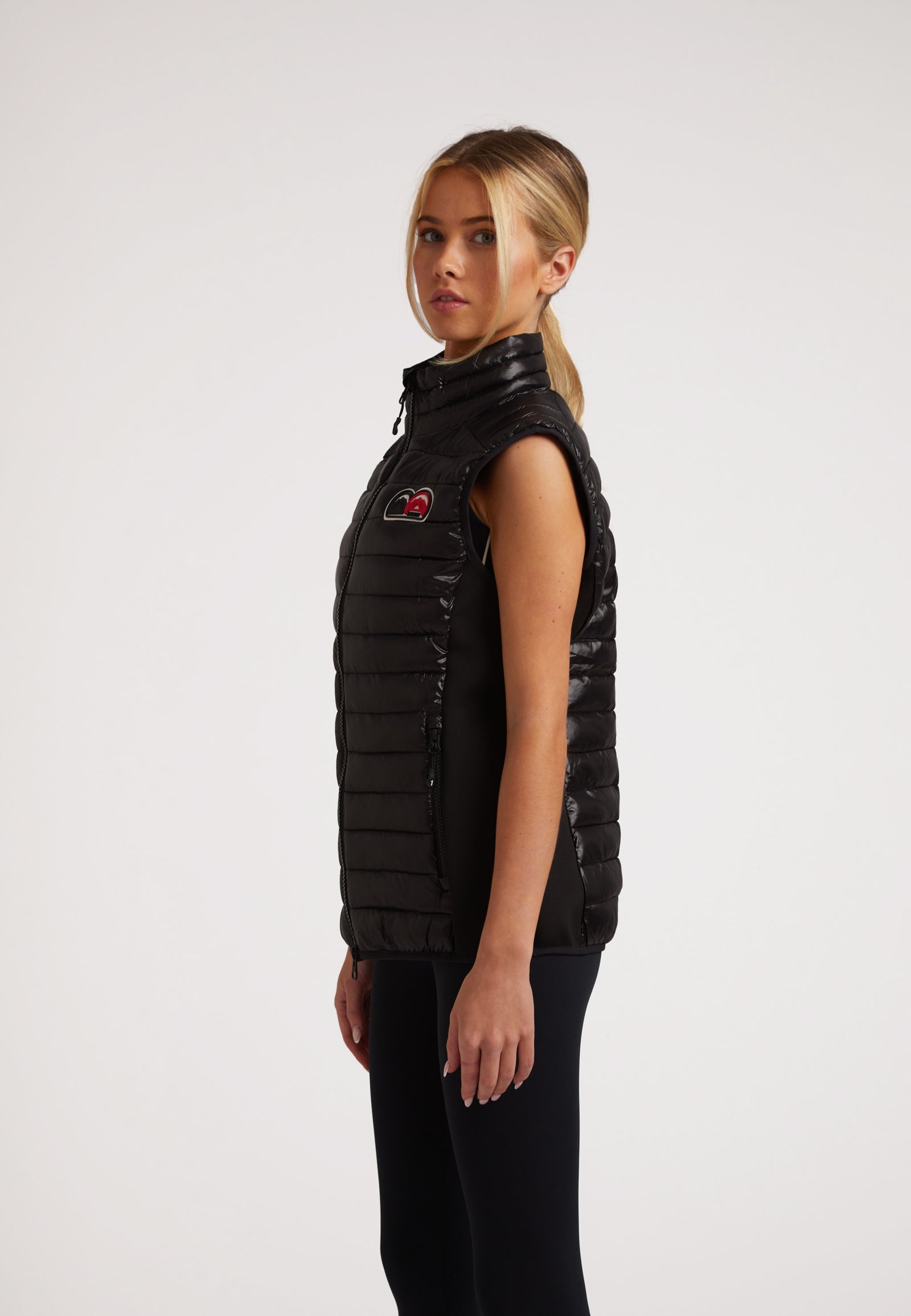 SPORTL1TE Funnel Lightweight Gilet 2.0 Lux Black worn by a model, showcasing its sleek design and lightweight features.