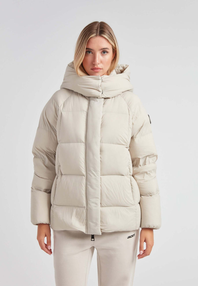 Cloud Prime Longline Down Puffer Jacket Stone displayed on a model wearing a light, stylish winter jacket.