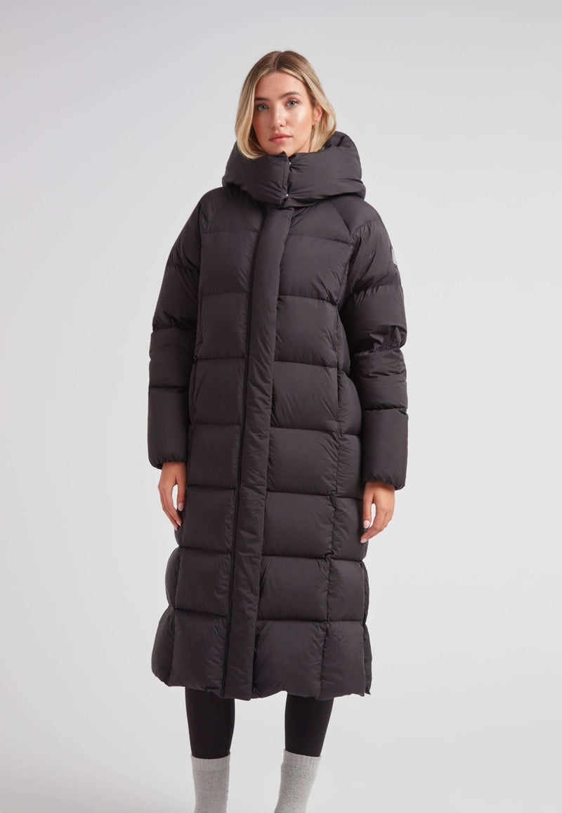 Model wearing a Long puffer jacket in black, featuring an adjustable hood and ankle-length design.