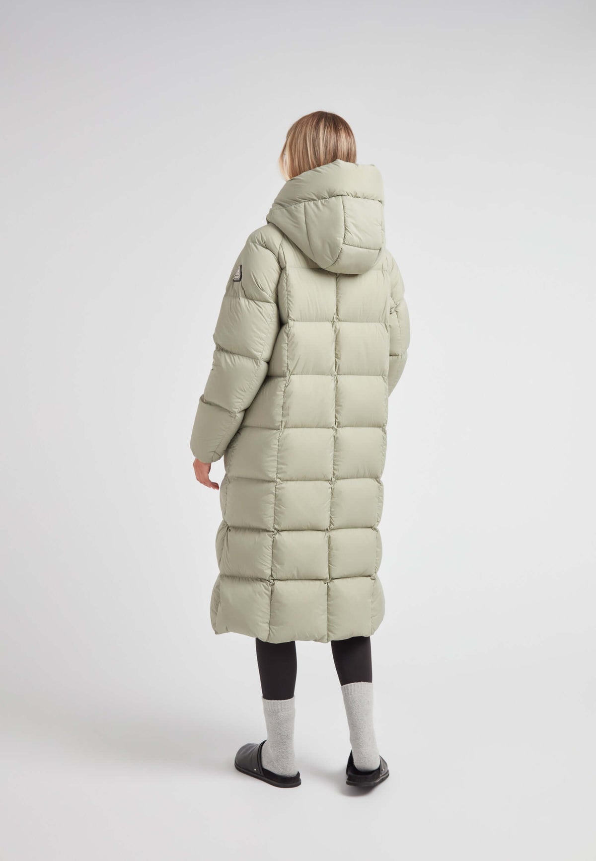 Back view of a woman wearing a Cloud Ultra Long Down Puffer Coat with a hood and ankle-length design.