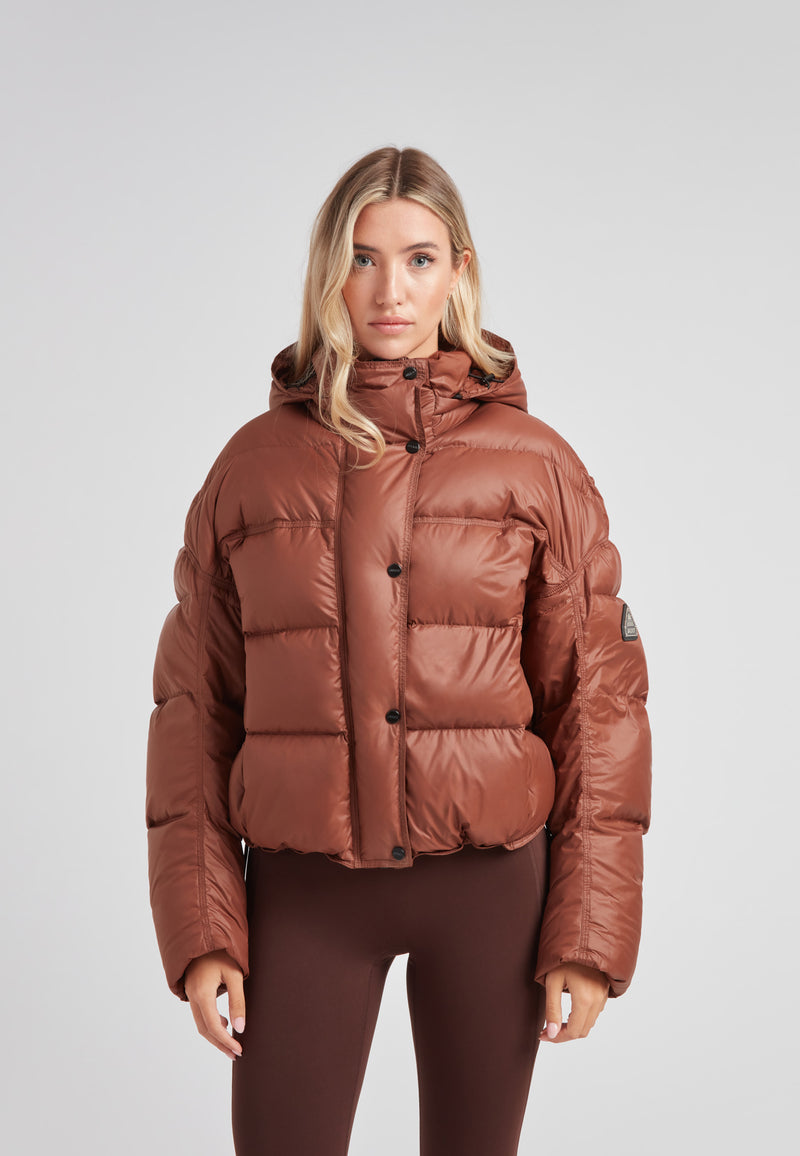 Cropped puffer in mocha brown with adjustable coverage for ladies, showcasing a stylish and oversized design.