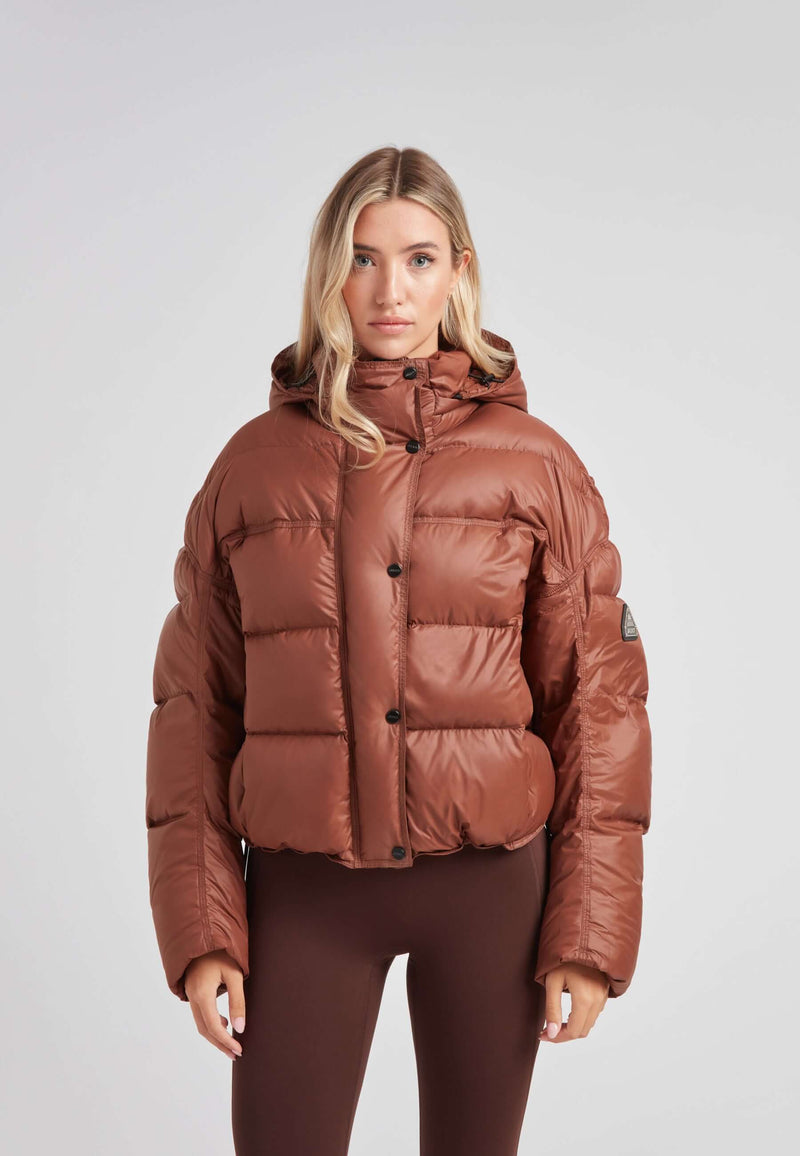 Cropped puffer in mocha brown with adjustable coverage for ladies, showcasing a stylish and oversized design.
