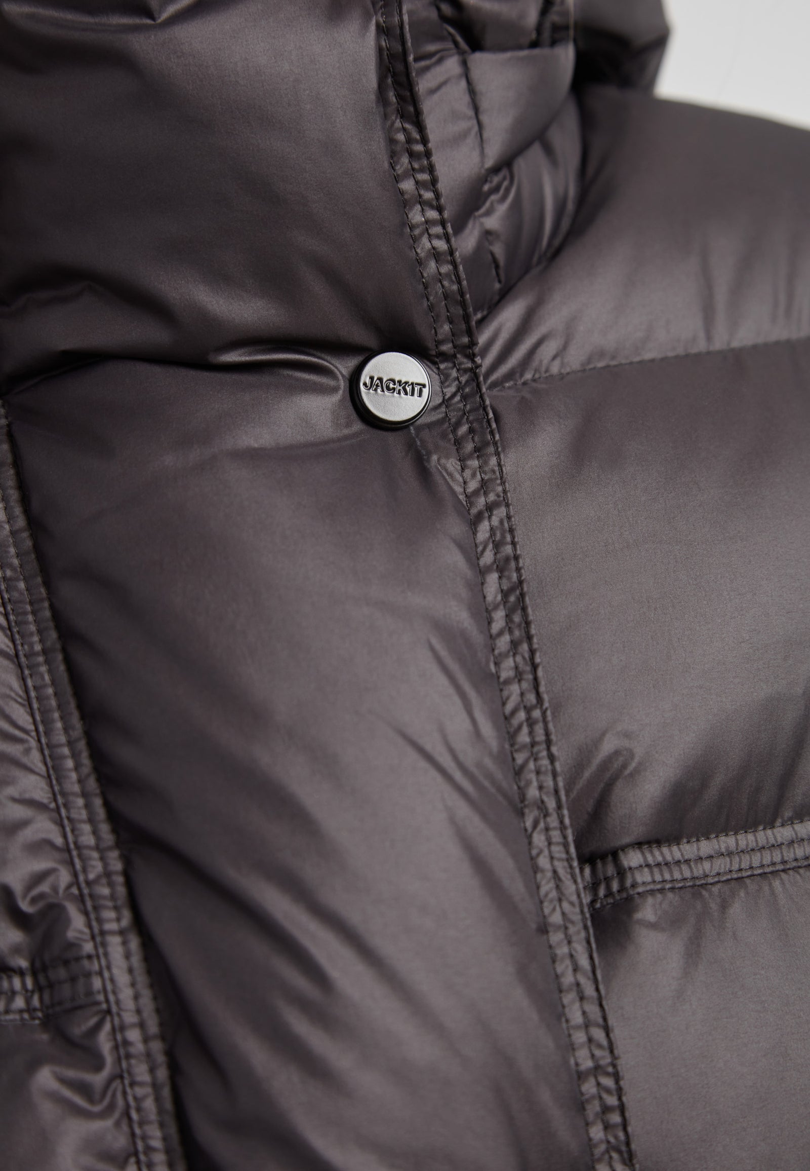 Close-up of the Cloud Boss cropped puffer in black with adjustable coverage showcasing the jacket's texture and detail.
