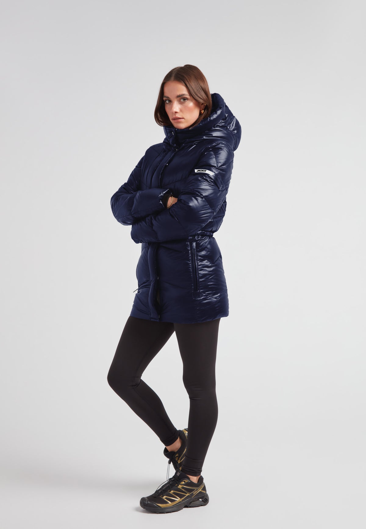 Womens navy down puffer coat with hood, mid-length, and water repellent shell, designed for everyday wear.
