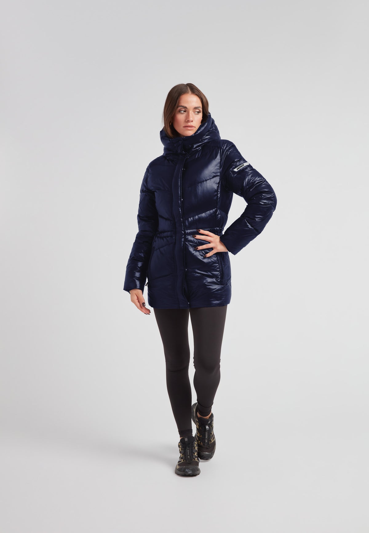Womens navy down puffer coat featuring a mid-length silhouette and water repellent shell.
