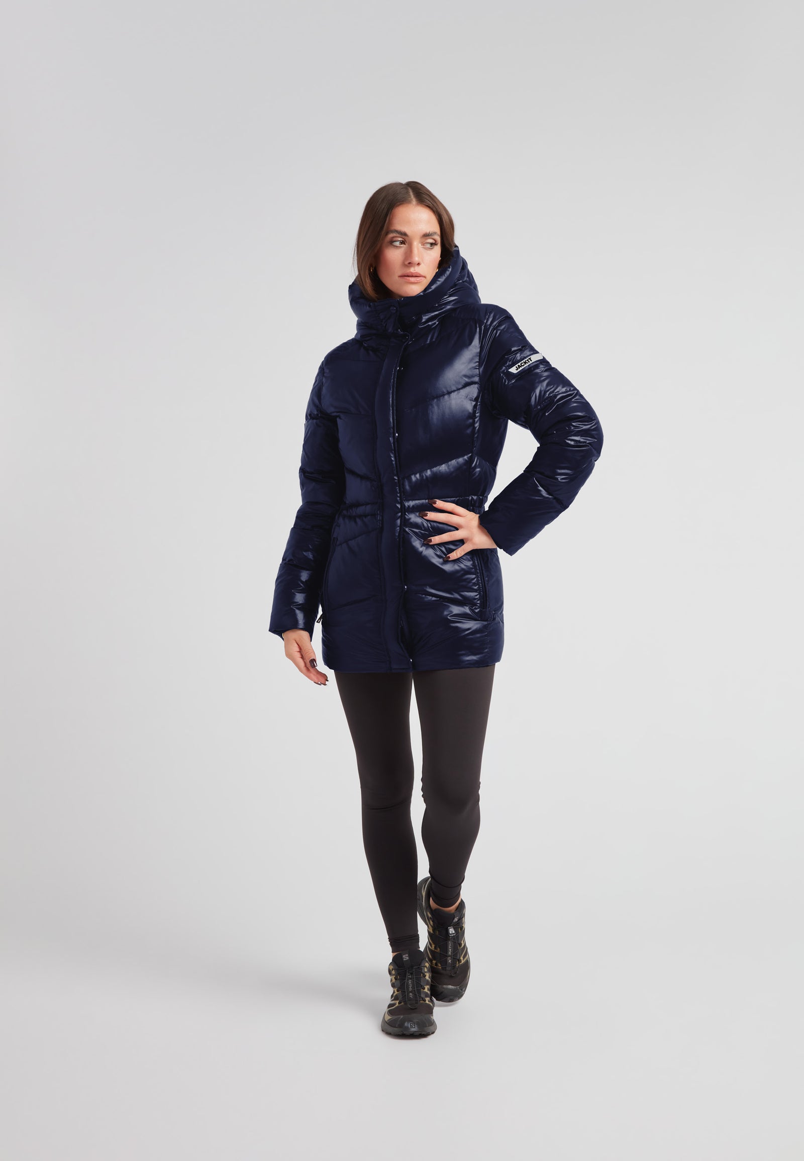 Womens navy down puffer coat featuring a mid-length silhouette and water repellent shell.
