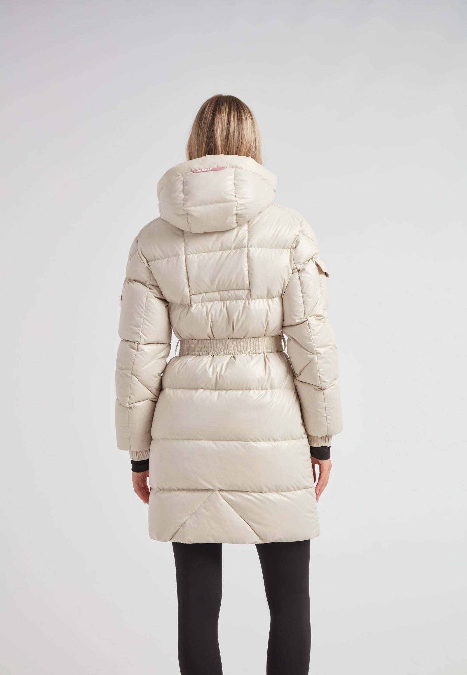 Back view of the EZ Belted Down Puffer Coat Lux Stone showcasing its stylish design and insulation features.