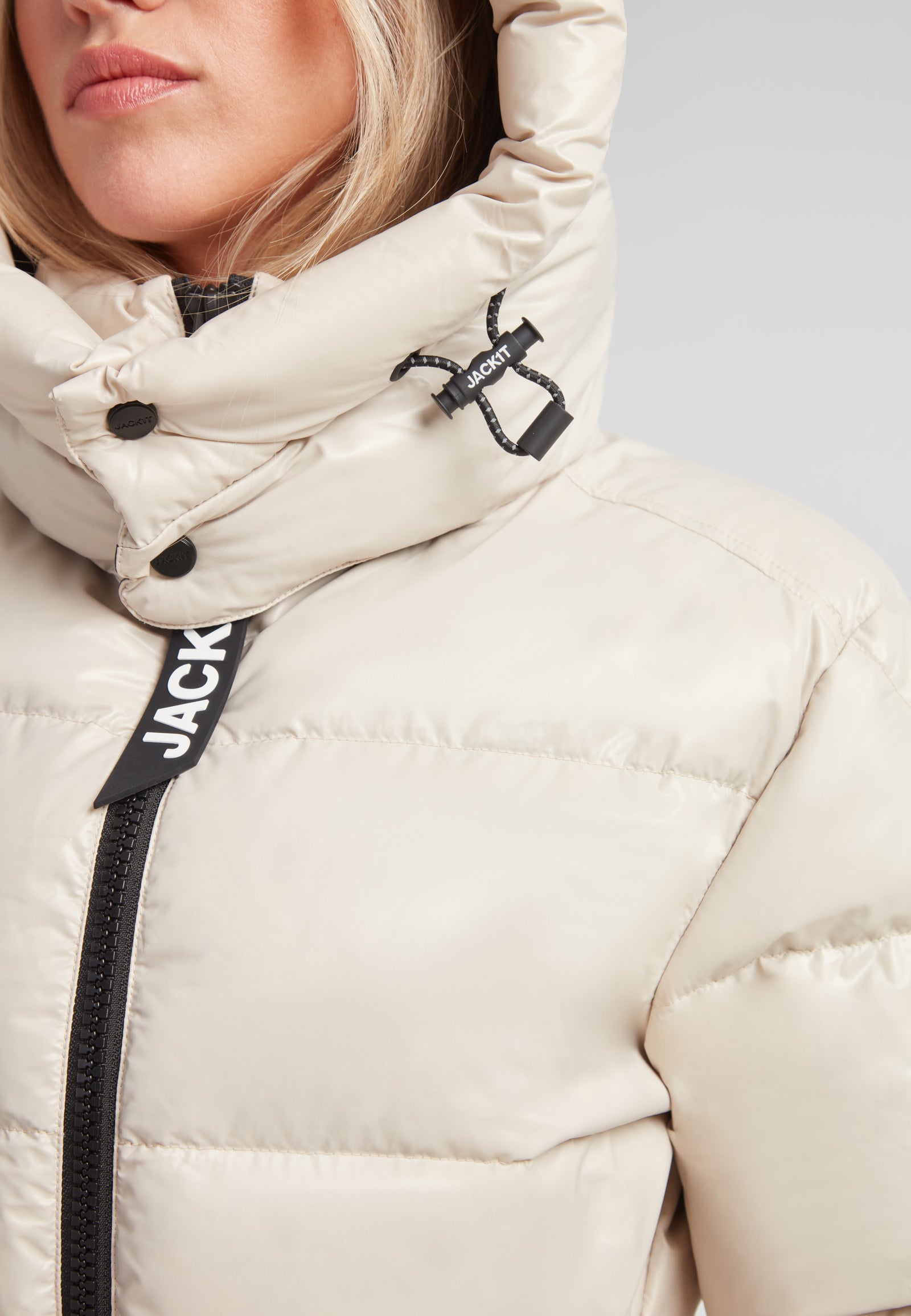 Close-up of the EZ Belted Down Puffer Coat Lux Stone featuring a stylish hood and refined design details.