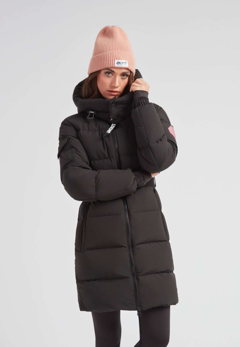 Model wearing the EZ Belted Down Puffer Coat Matt Black with a pink beanie, showcasing its stylish design.