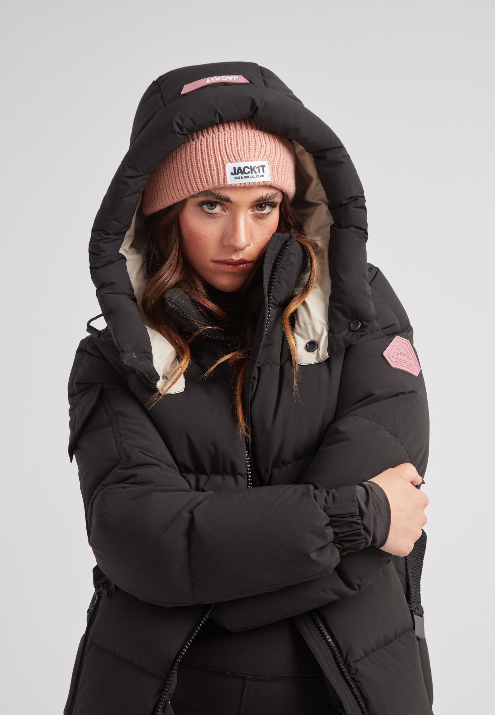 EZ Belted Down Puffer Coat Matt Black worn by a model with a pink beanie, showcasing winter fashion and functionality.