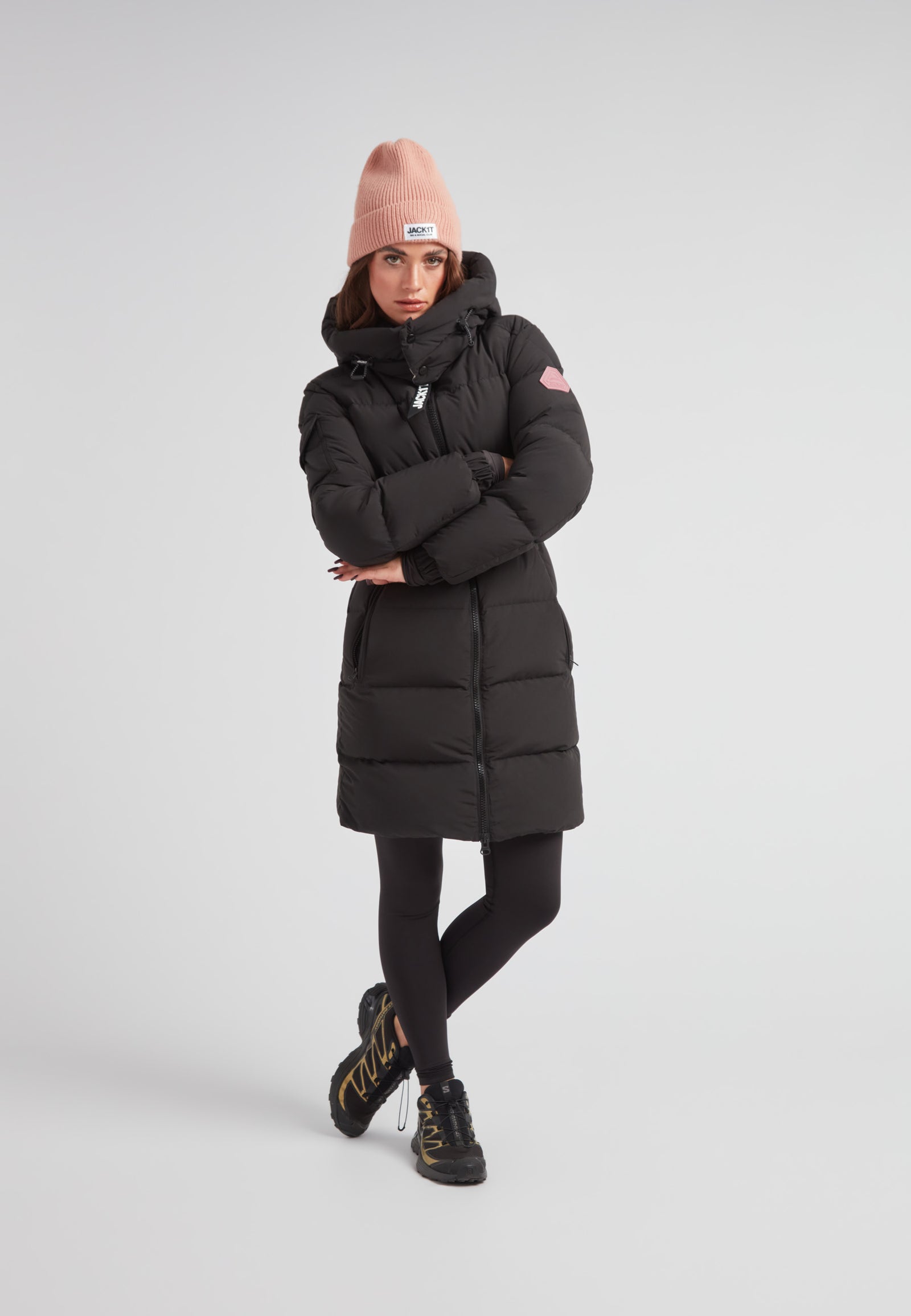 Model wearing the EZ Belted Down Puffer Coat Matt Black with a pink beanie and stylish boots.
