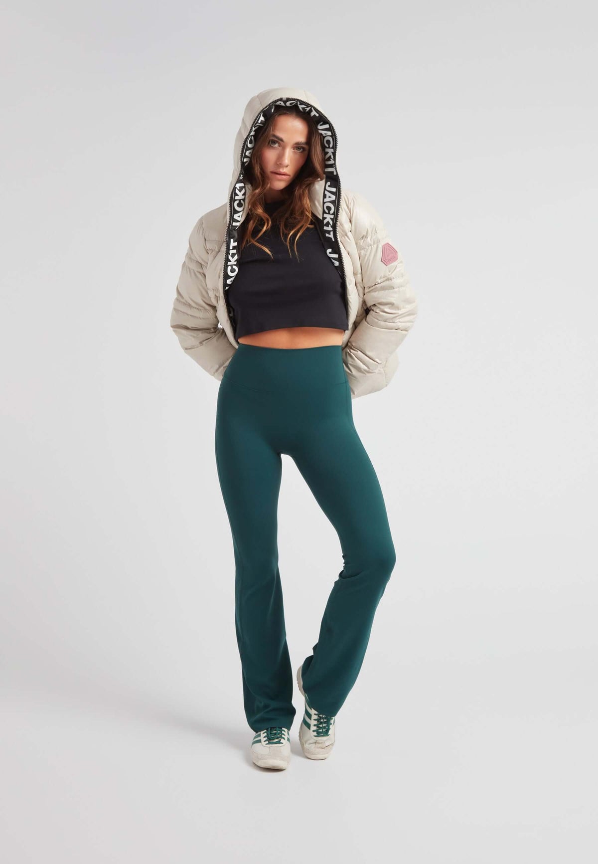Model wearing R4D Tramline Puffer Racer Jacket Lux Stone with green pants and sneakers.