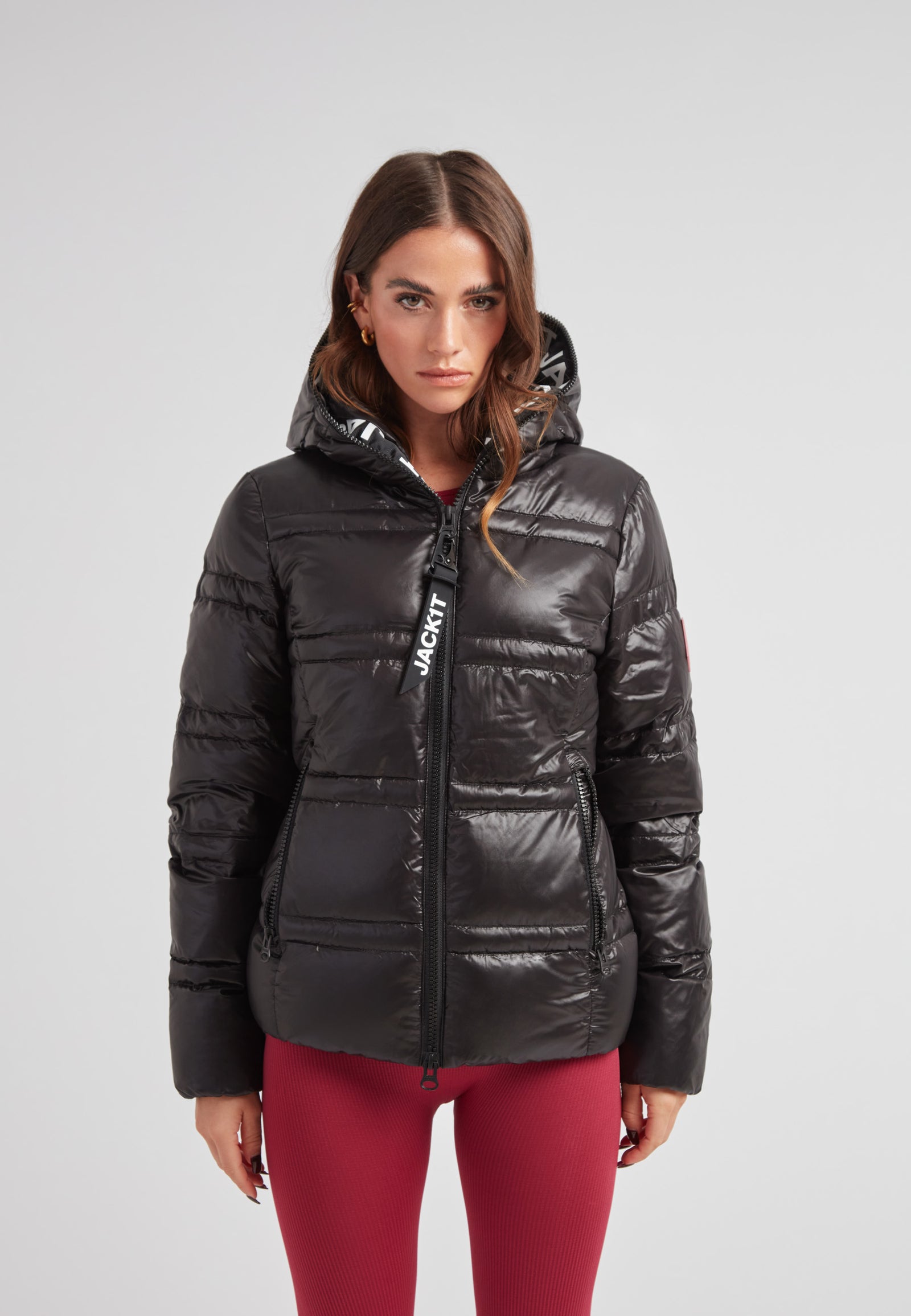 R4D Tramline Puffer Racer Jacket Lux Black worn by model, showcasing its sleek design and hood.