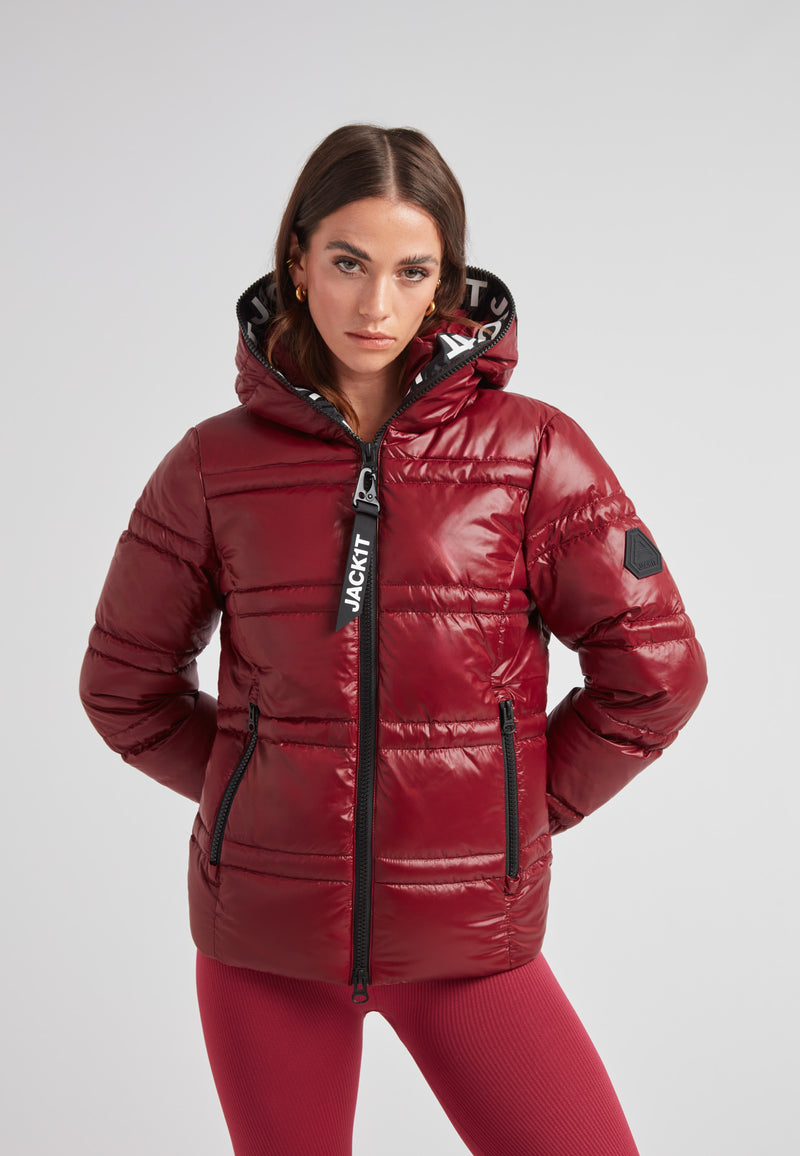 Model wearing the R4D Tramline Puffer Racer Jacket Lux Cranberry with a fixed hood and stylish design.