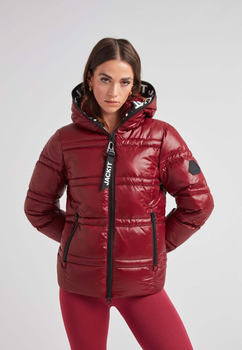 Model wearing the R4D Tramline Puffer Racer Jacket Lux Cranberry with a fixed hood and stylish design.