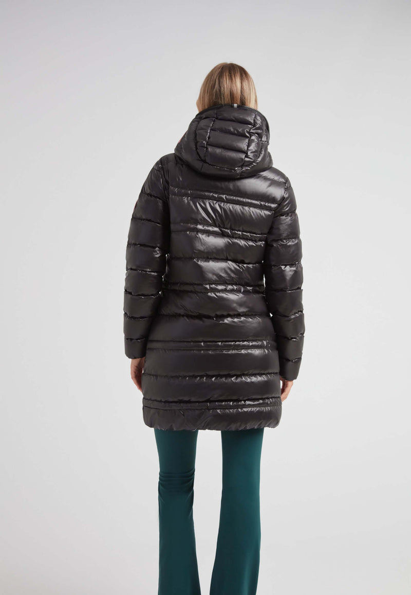 R4D Tramline Down Coat Lux Black worn by a woman, showcasing the back view with a sleek design and hood.